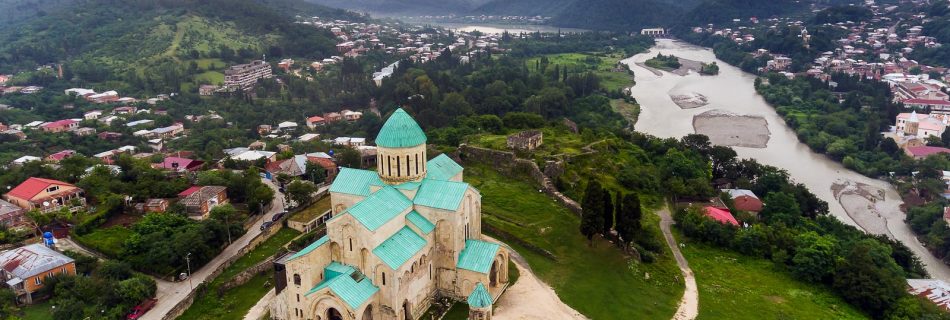 Vue aérienne de la cathédrale Bagrati à Kutaisi, coupole et murs en pierre entourés de bâtiments et d'espaces verts