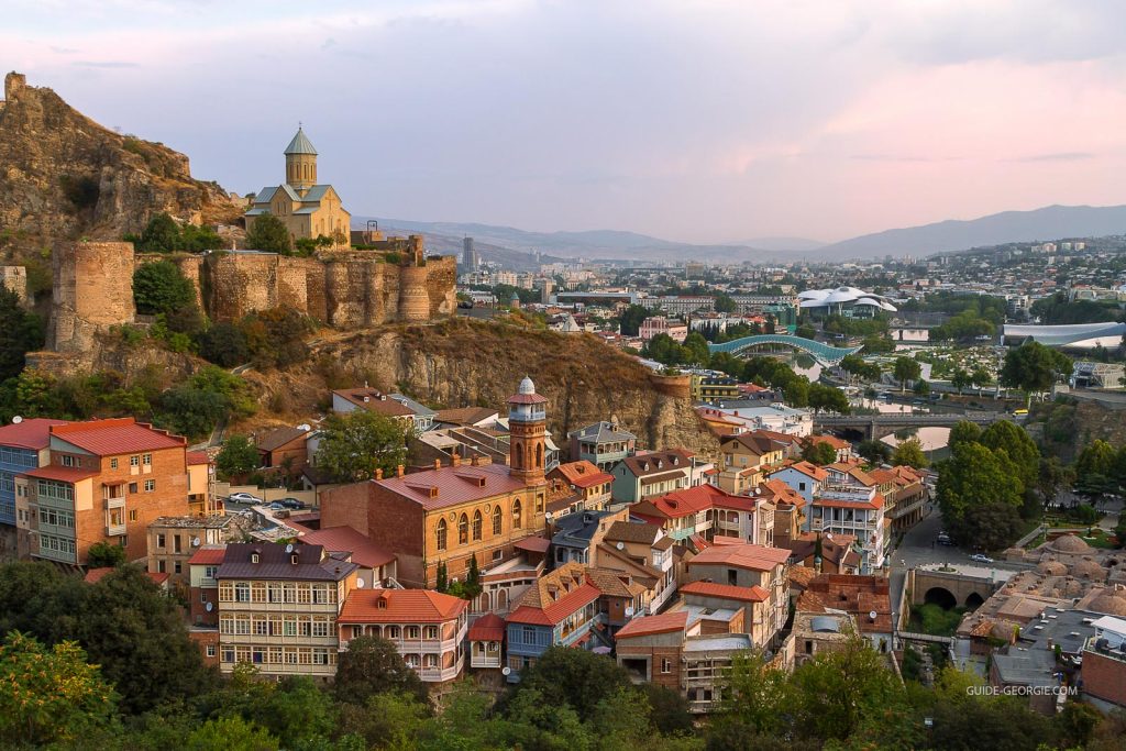 Vue aérienne du skyline de Tbilissi au crépuscule avec la forteresse de Narikala en surplomb