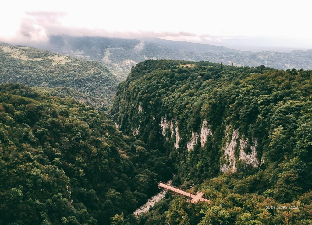 Canyon vu du ciel avec vallées profondes, zones boisées et nuages au-dessus